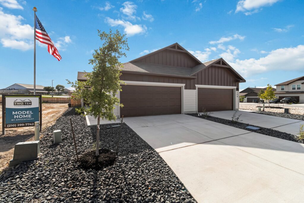 A completed home with drives and landscaping in.