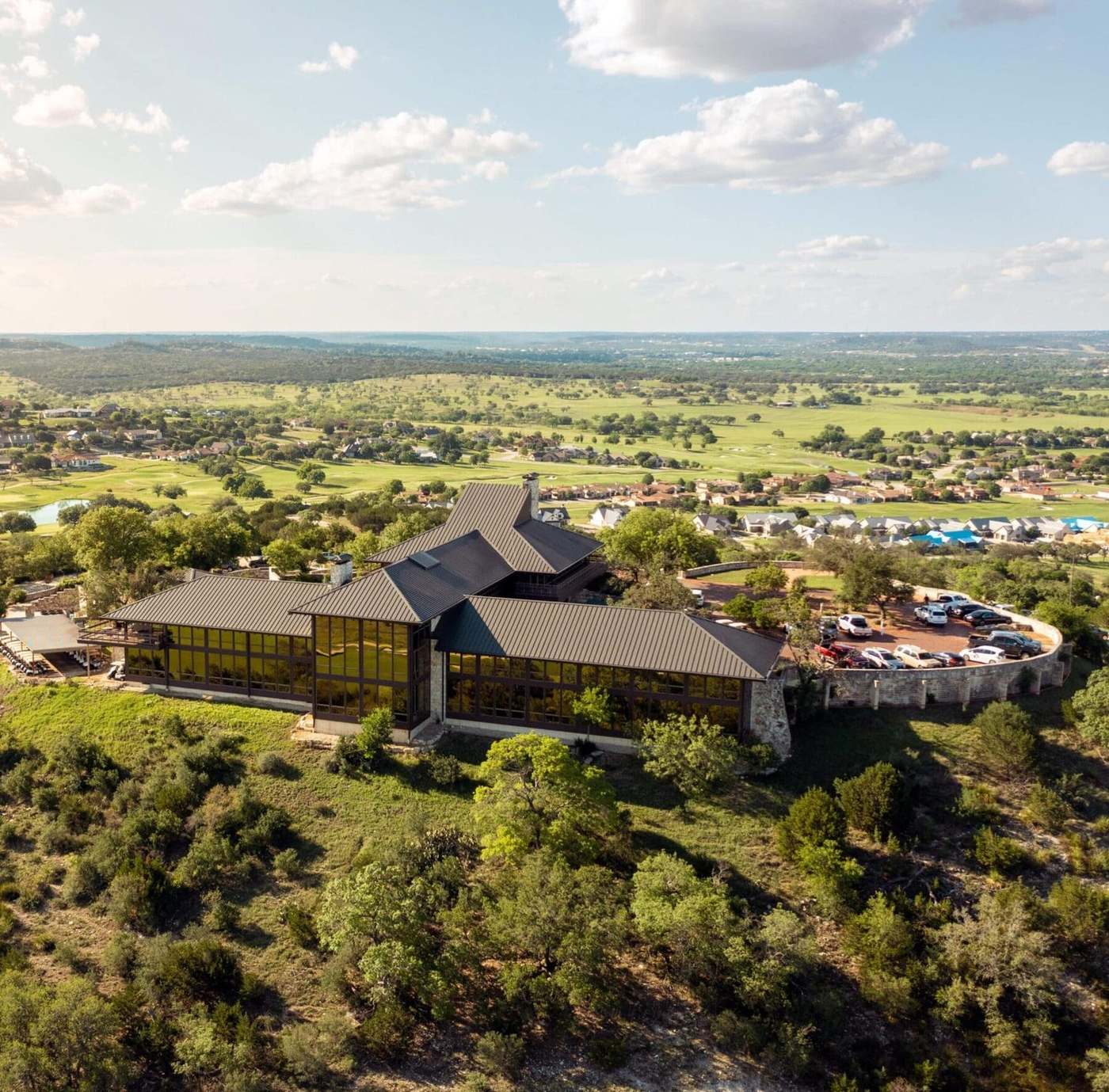 The clubhouse above the course, looking out over the Hill Country.