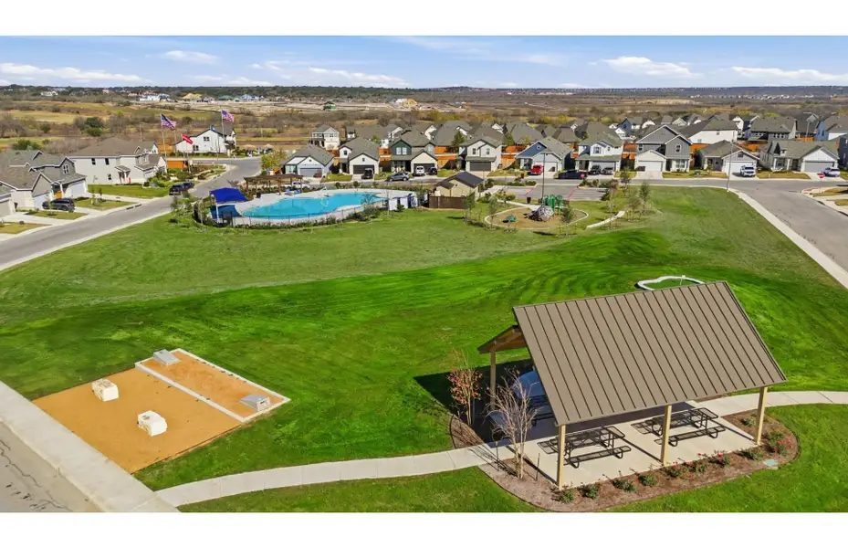 The amenity area from above — pavilion, pool court, playground and connecting walks.