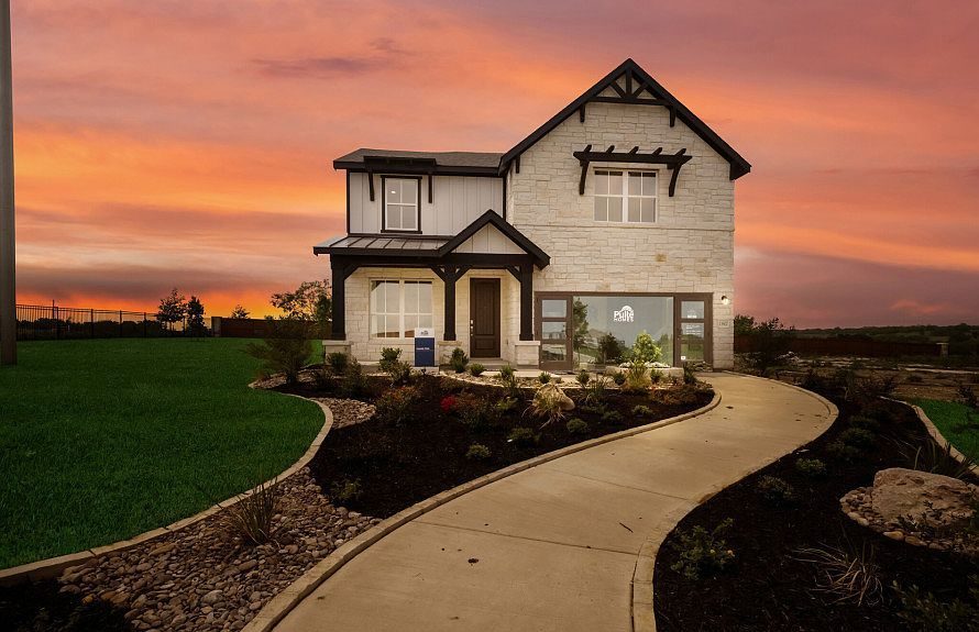 A finished home with walks and landscaping complete.