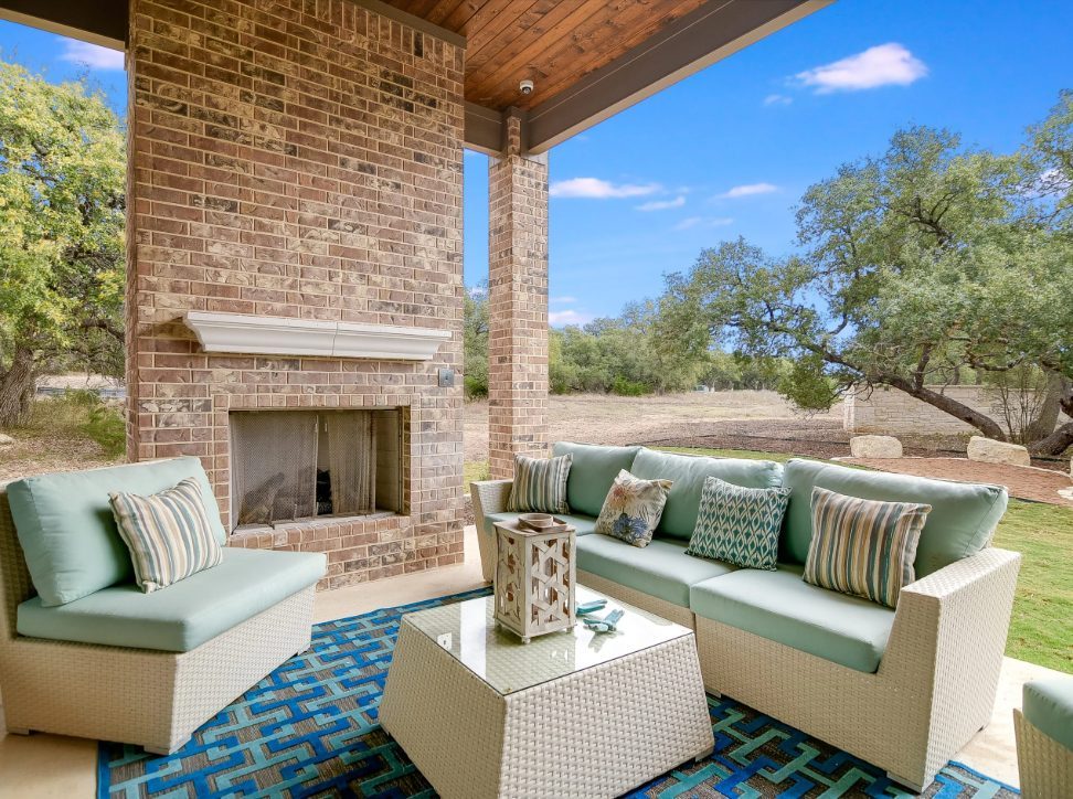 Covered outdoor living with a full masonry fireplace.